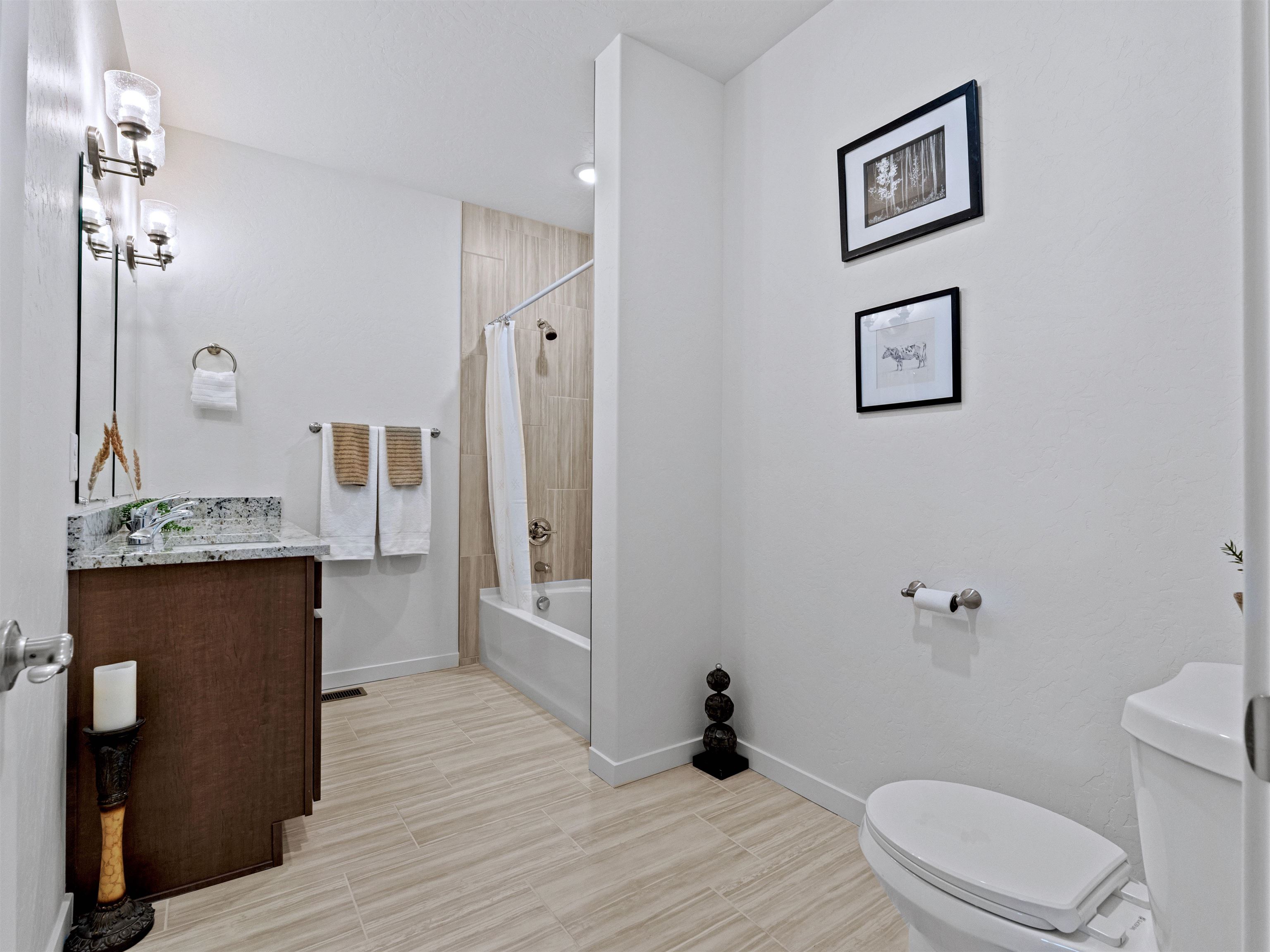 2147 Moon River Road Grand Junction, CO 81505 - Photo 24 of 34 a bathroom with a granite countertop sink toilet a mirror and shower