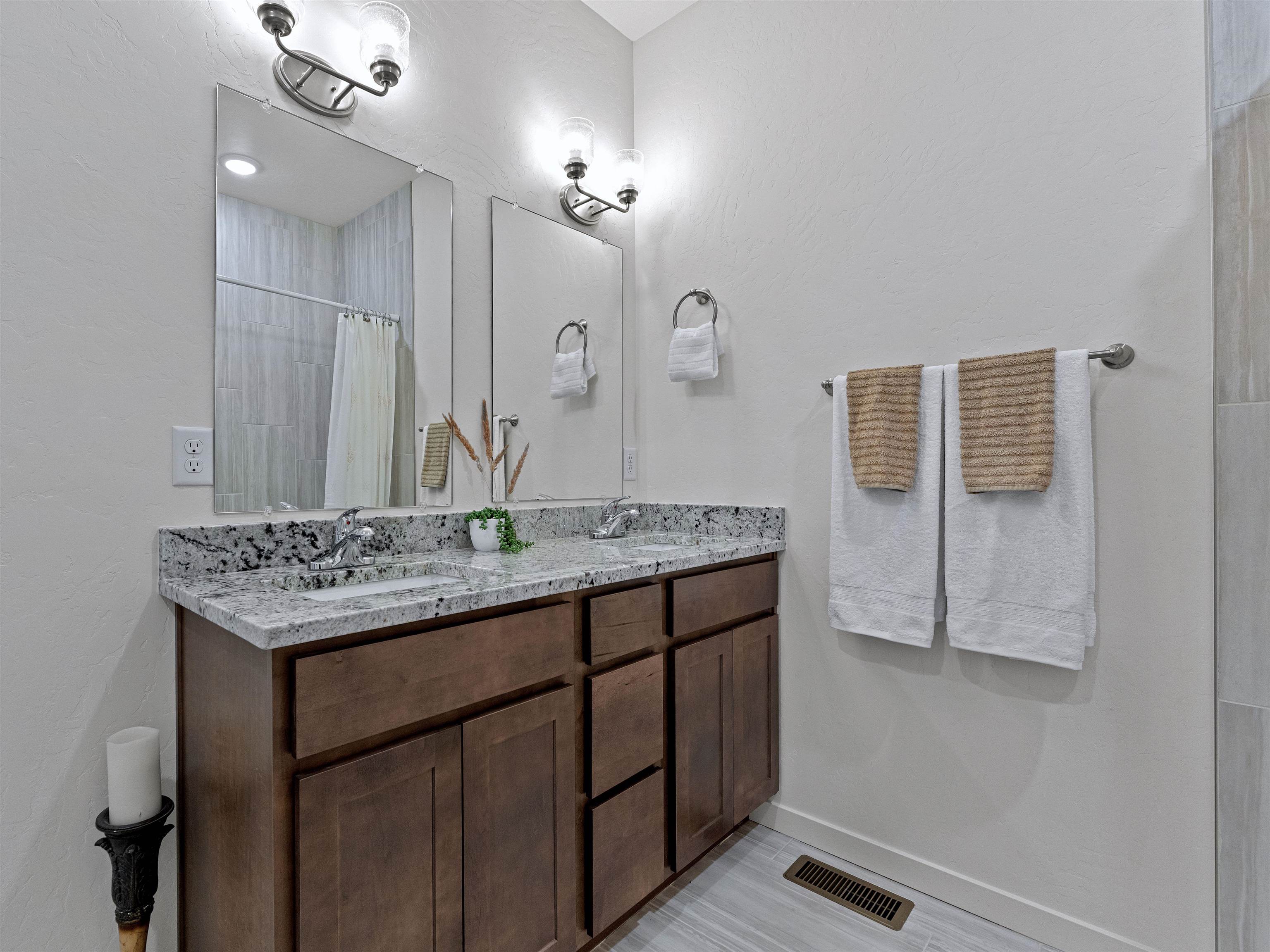 2147 Moon River Road Grand Junction, CO 81505 - Photo 25 of 34 a bathroom with a granite countertop sink a large mirror and shower