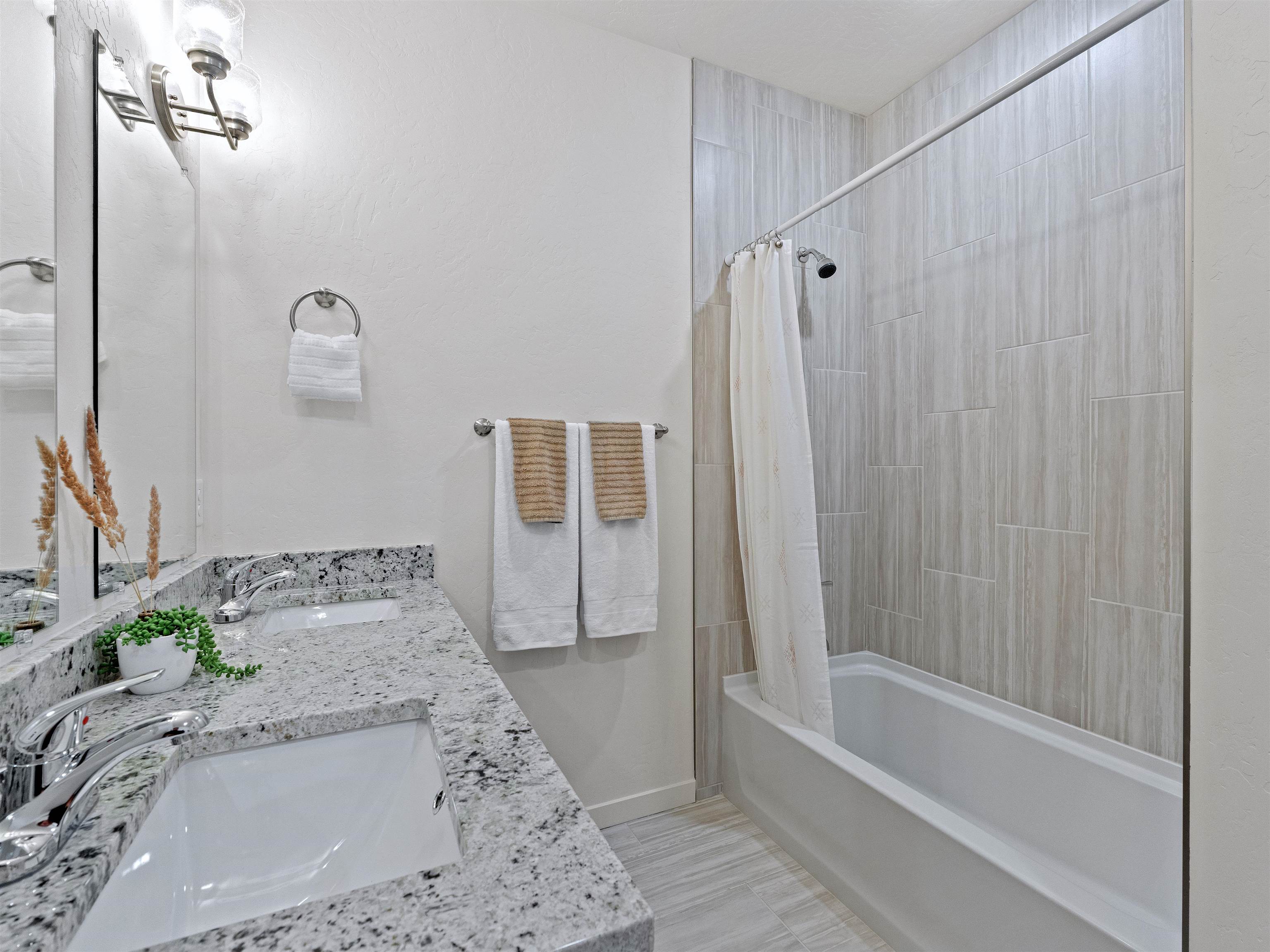 2147 Moon River Road Grand Junction, CO 81505 - Photo 26 of 34 a bathroom with a granite countertop sink and a bathtub