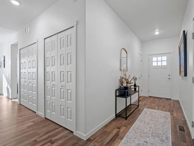 a view of a livingroom with wooden floor and stairs