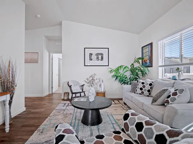 a living room with furniture and wooden floor