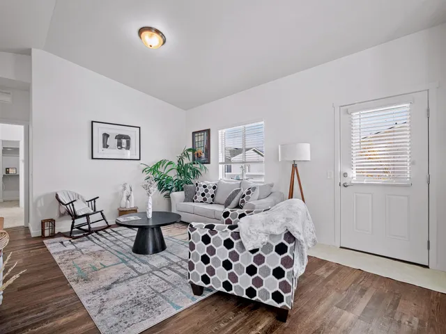a living room with furniture and wooden floor