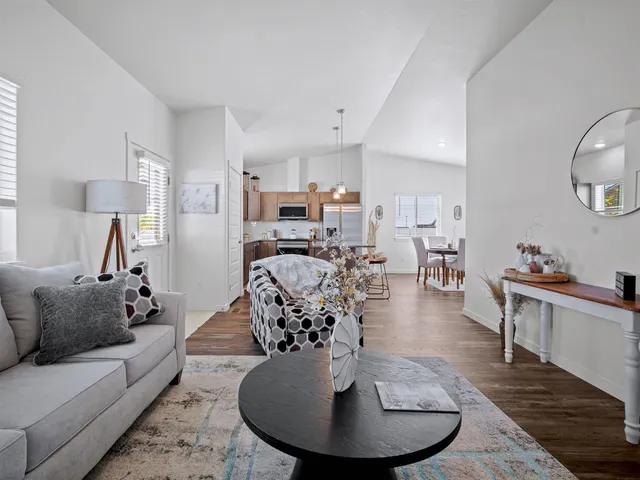 a living room with furniture kitchen view and a dining table