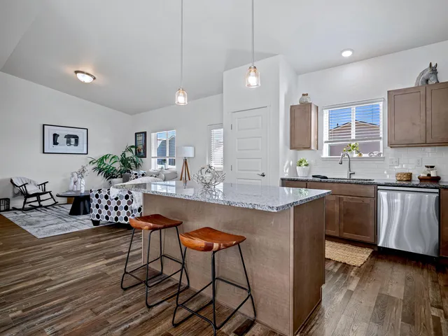 a kitchen with granite countertop white cabinets and stainless steel appliances