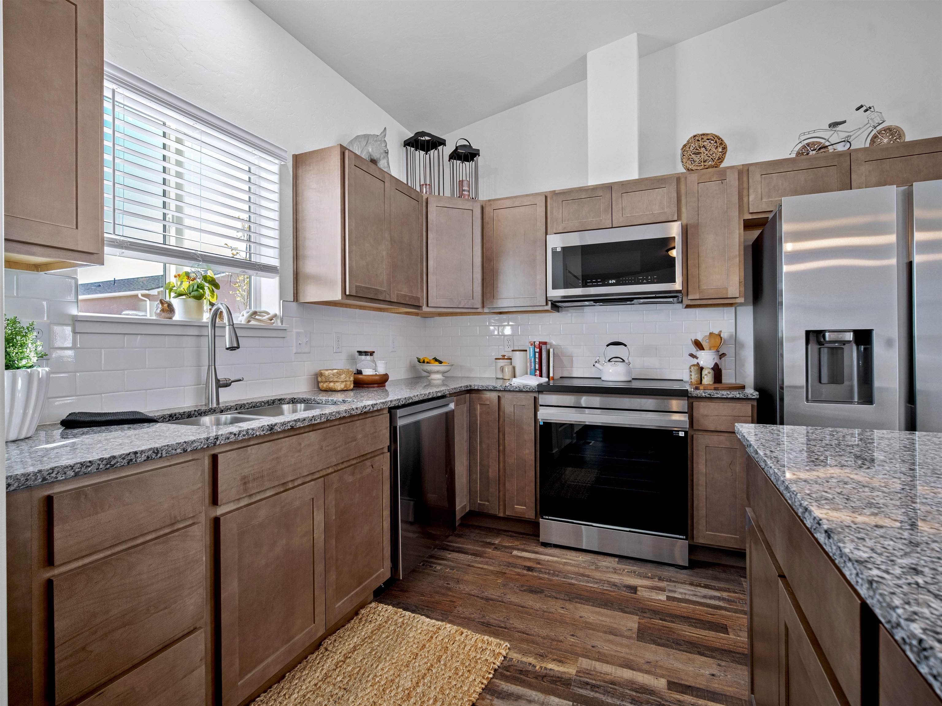 2147 Moon River Road Grand Junction, CO 81505 - Photo 8 of 34 a kitchen with stainless steel appliances granite countertop a sink stove and refrigerator