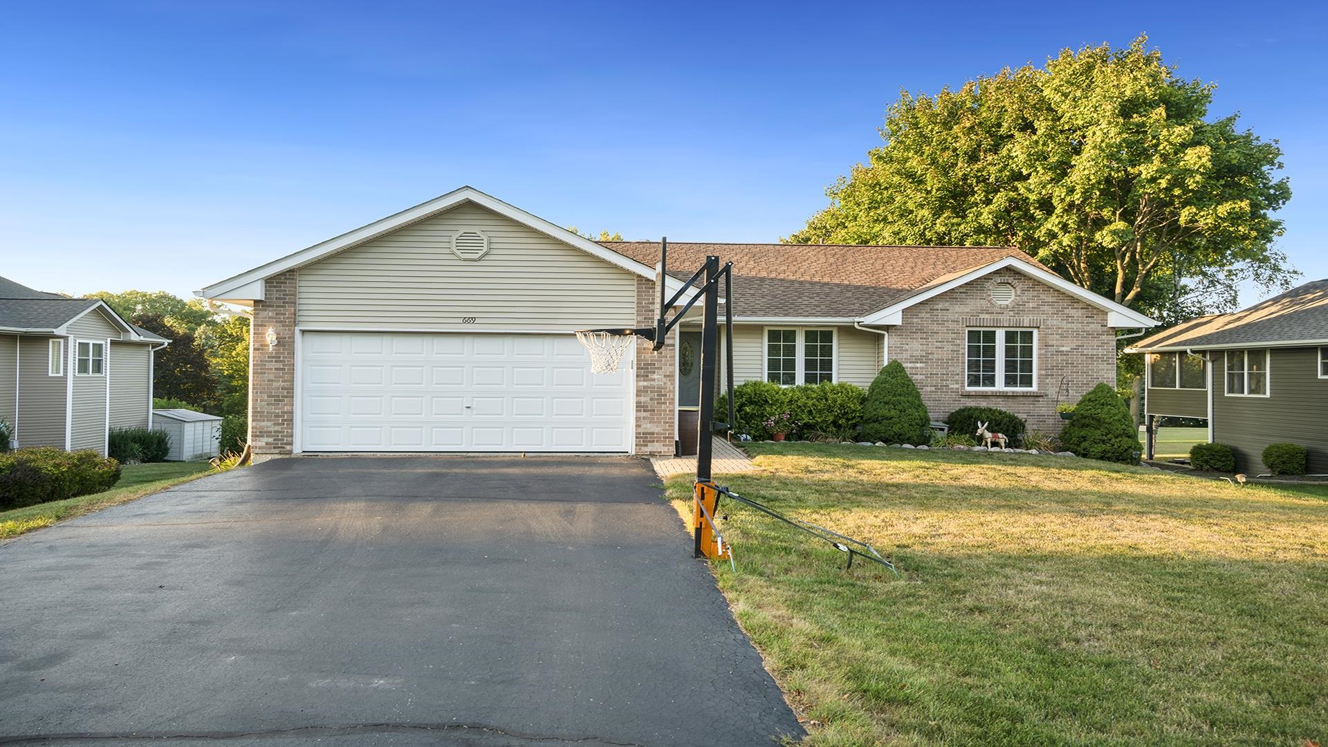 669 Lake Summerset Road Davis, IL 61019 - Photo 1 of 36 a front view of a house with a yard and garage