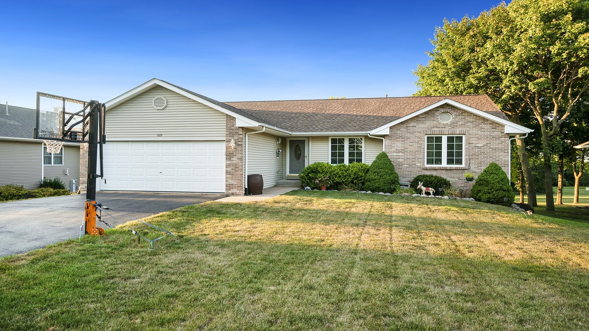 669 Lake Summerset Road Davis, IL 61019 - Photo 2 of 36 a front view of a house with a yard and garage