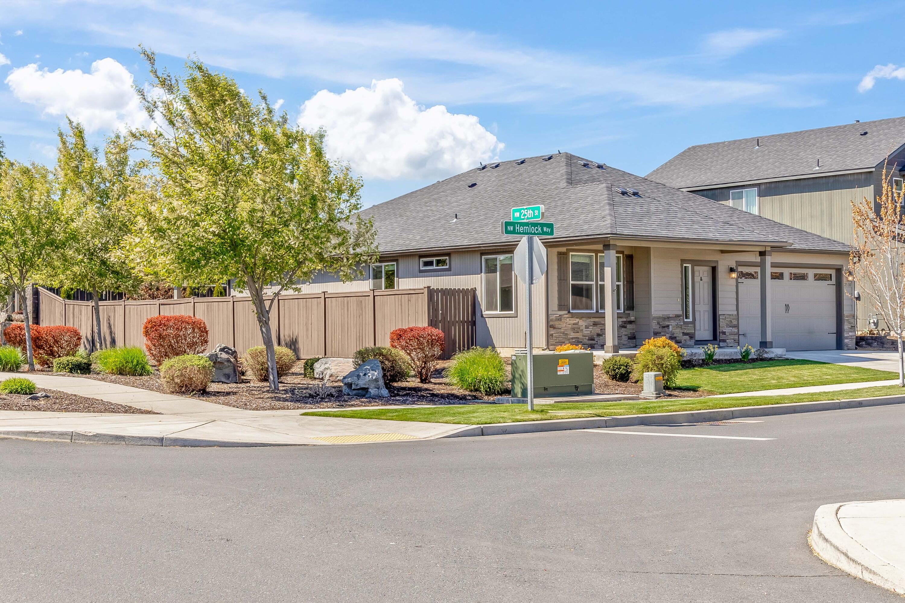 2510 Northwest Hemlock Way Redmond, OR 97756 - Photo 2 of 32 a front view of a house with a yard outdoor seating and garage