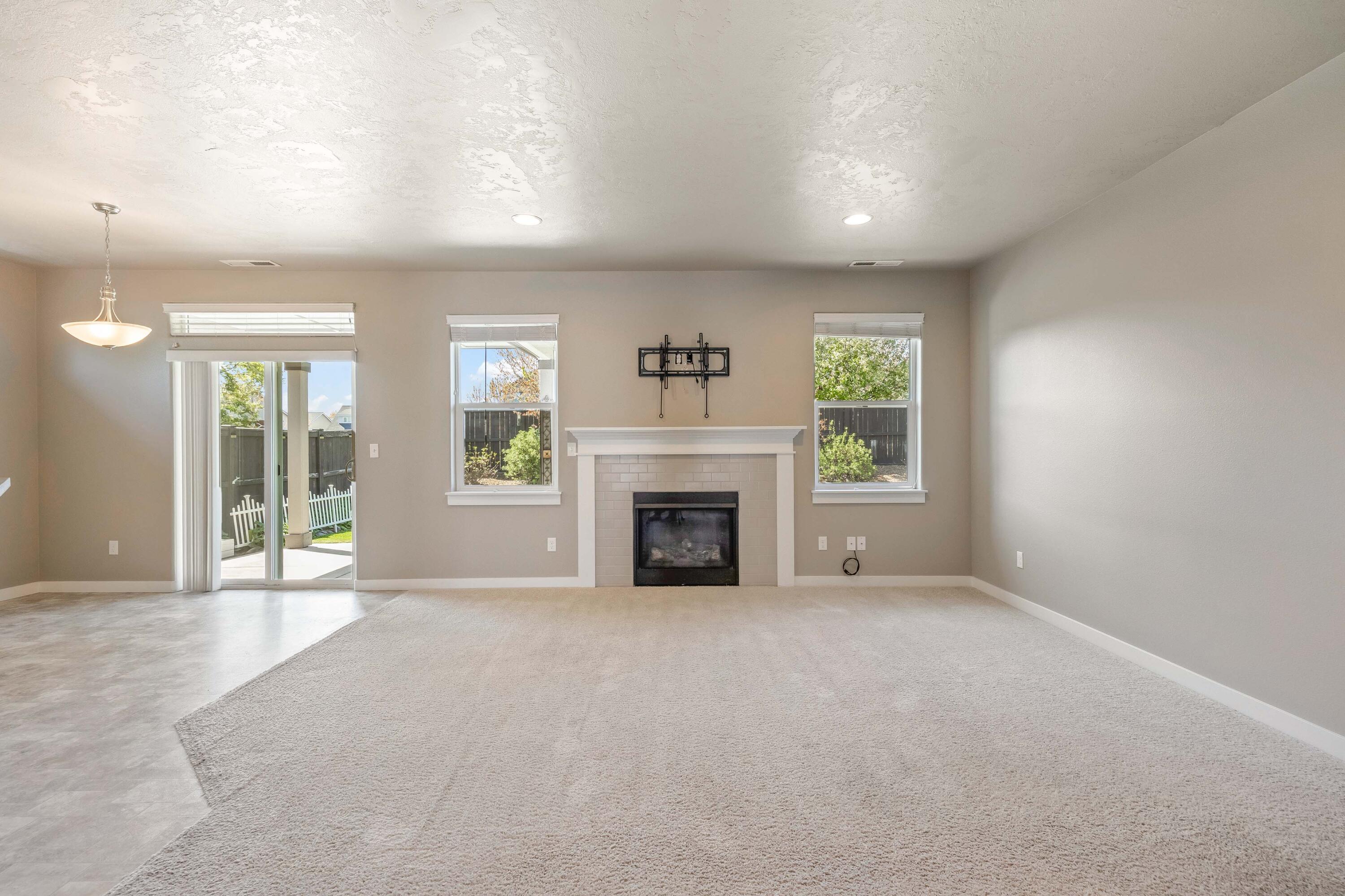 2510 Northwest Hemlock Way Redmond, OR 97756 - Photo 4 of 32 a view of an empty room with a fireplace and a window