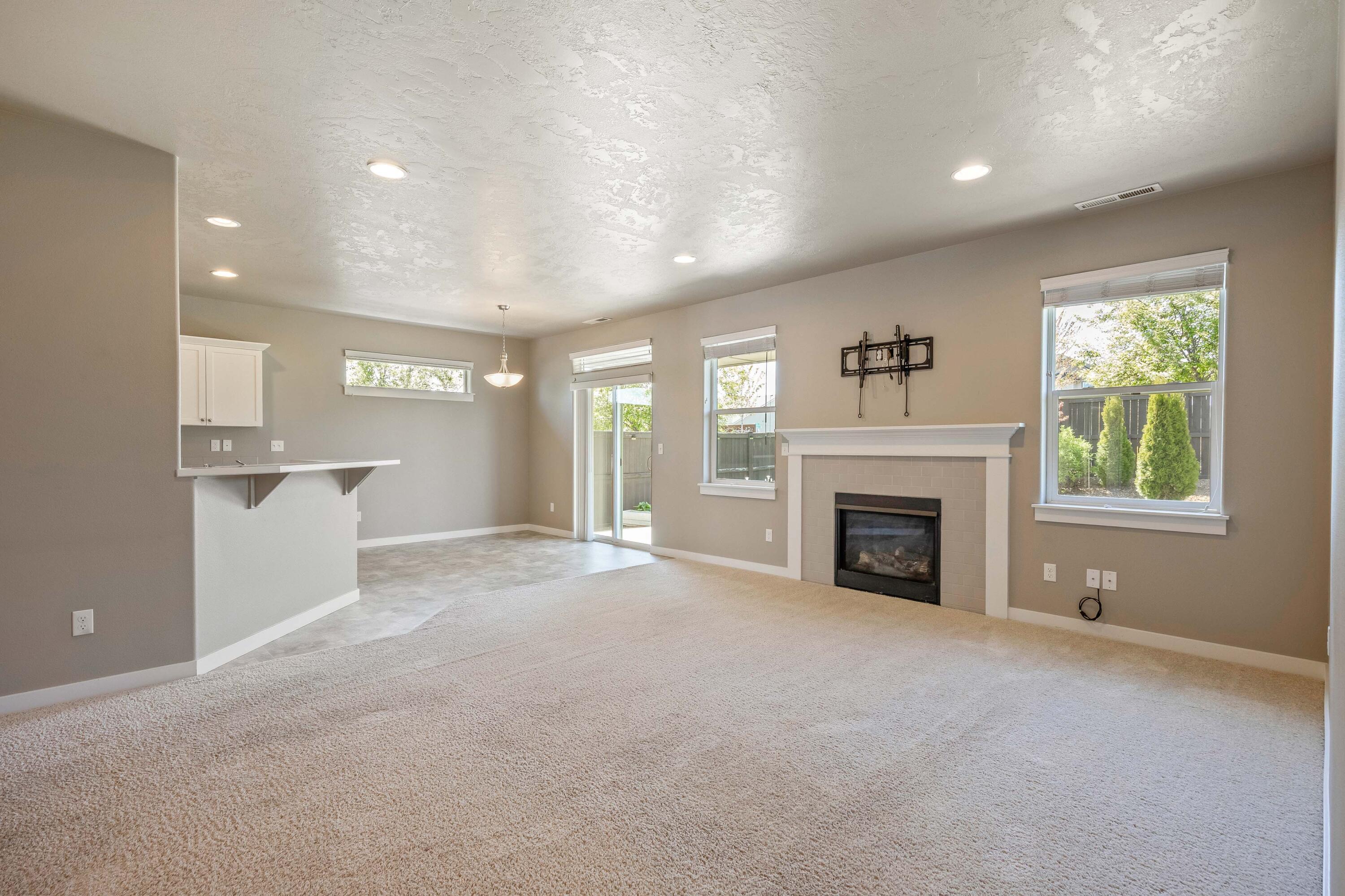 2510 Northwest Hemlock Way Redmond, OR 97756 - Photo 6 of 32 a view of empty room with a fireplace and window