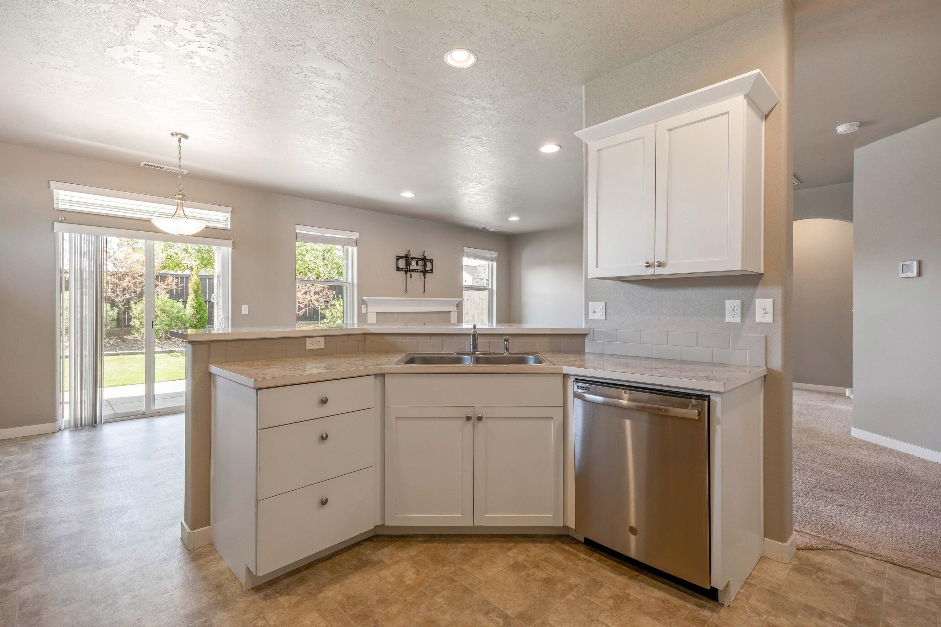 2510 Northwest Hemlock Way Redmond, OR 97756 - Photo 8 of 32 a kitchen with white cabinets and sink