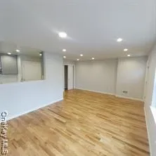 a view of an empty room with a kitchen