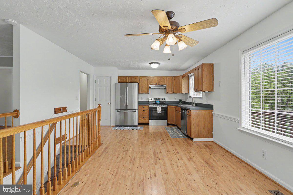 543 Whiskey Still Road Linden, VA 22642 - Photo 10 of 23 a view of a kitchen with a sink cabinets and wooden floor