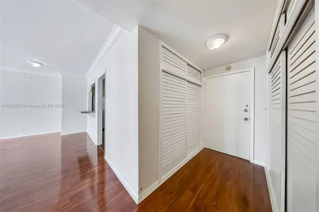 a view of hallway with wooden floor