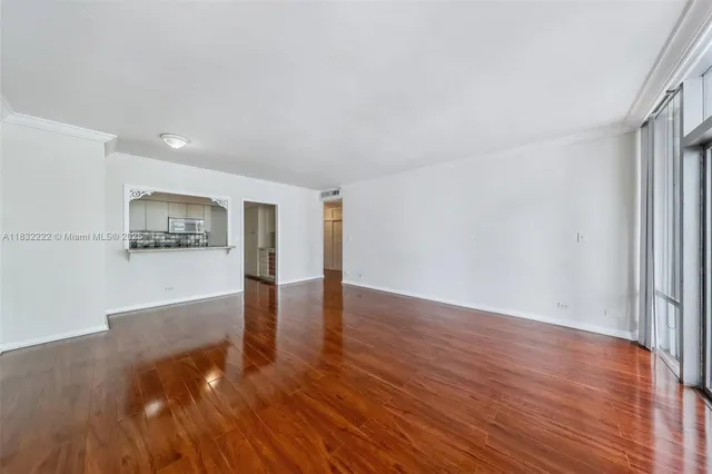 a room with wooden floor and a ceiling fan