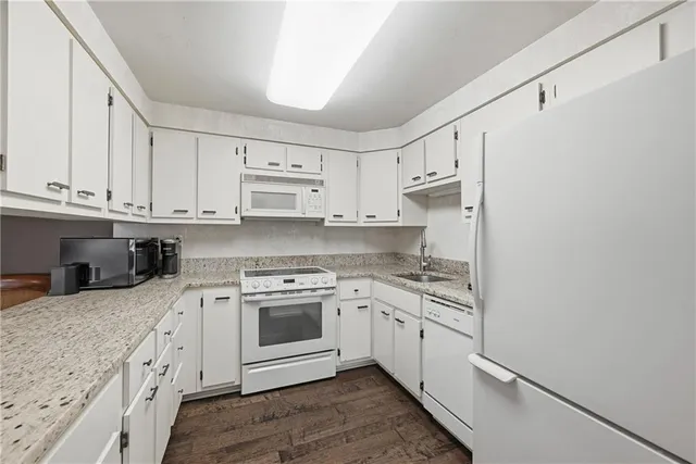 a kitchen with stainless steel appliances granite countertop a stove sink and cabinets