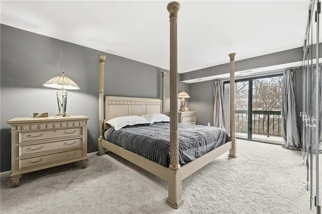 a bedroom with a bed and a lamp with the balcony