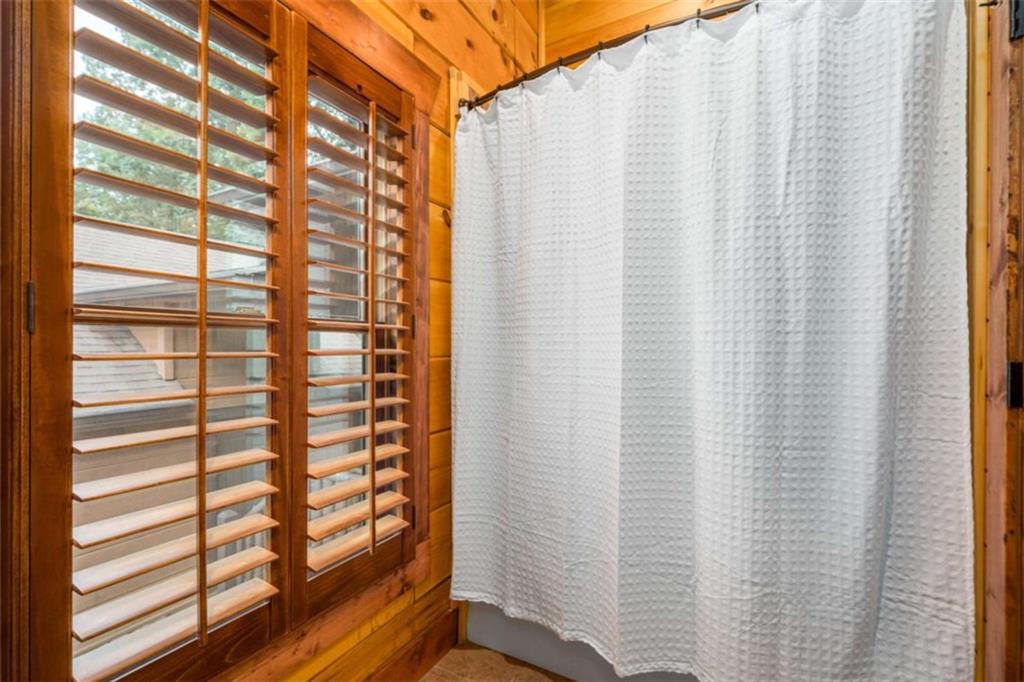 31 High Cliff Road Jasper, GA 30143 - Photo 22 of 50 a view of a bathroom with a shower curtain