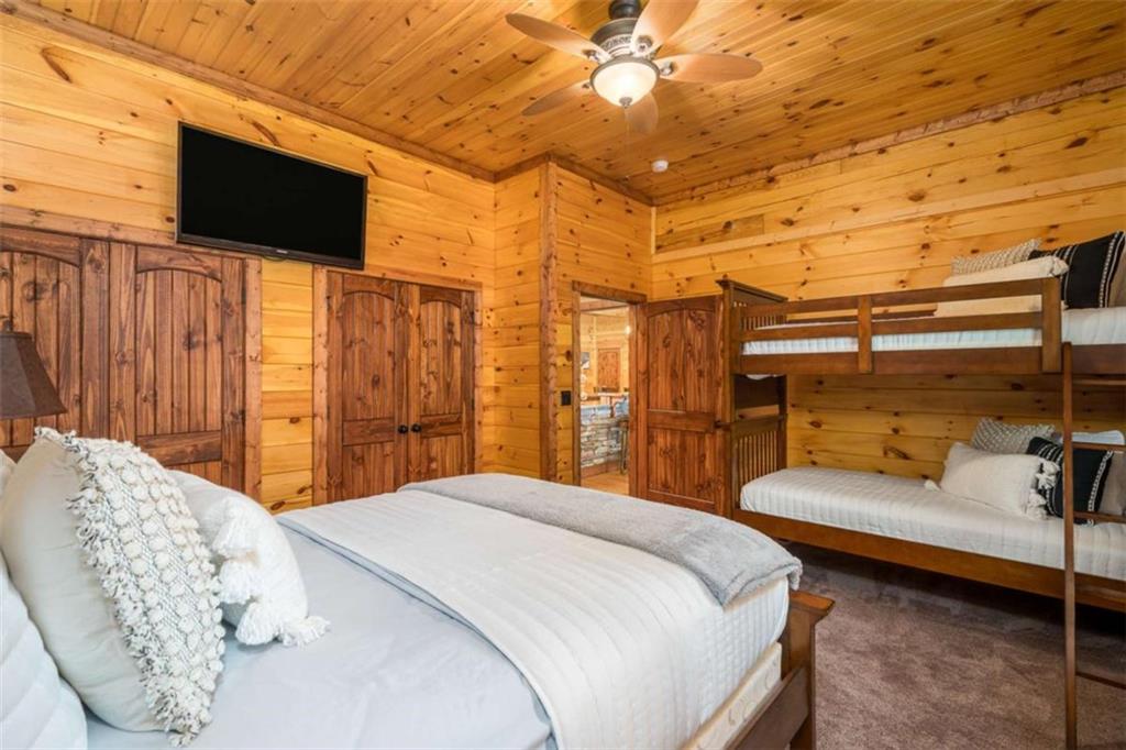 31 High Cliff Road Jasper, GA 30143 - Photo 24 of 50 a bedroom with a bed and a flat screen tv