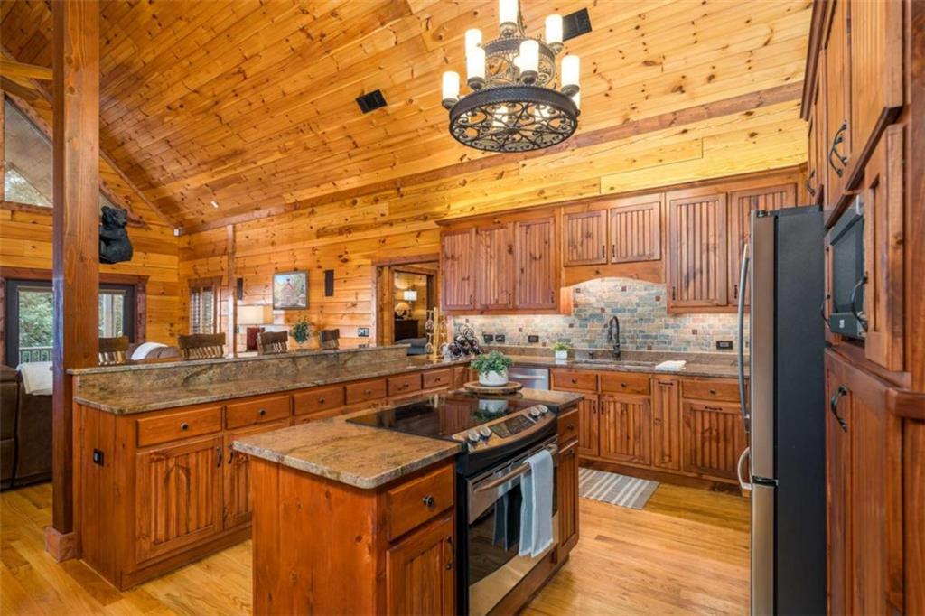 31 High Cliff Road Jasper, GA 30143 - Photo 6 of 50 a kitchen with stainless steel appliances granite countertop a stove and a refrigerator