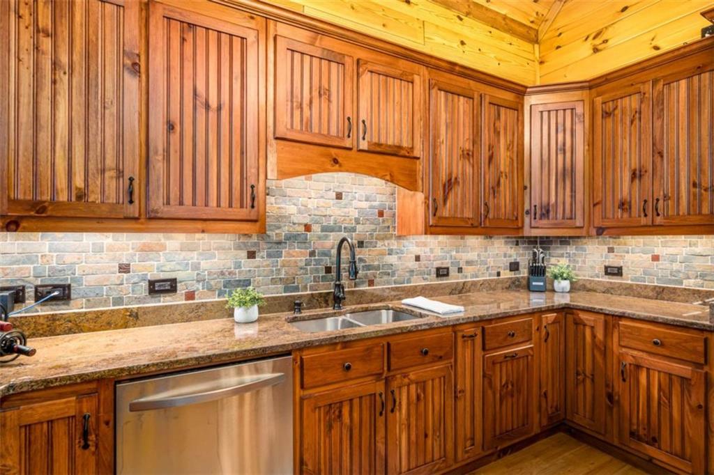 31 High Cliff Road Jasper, GA 30143 - Photo 7 of 50 a kitchen with stainless steel appliances granite countertop a sink a stove a counter space and cabinets