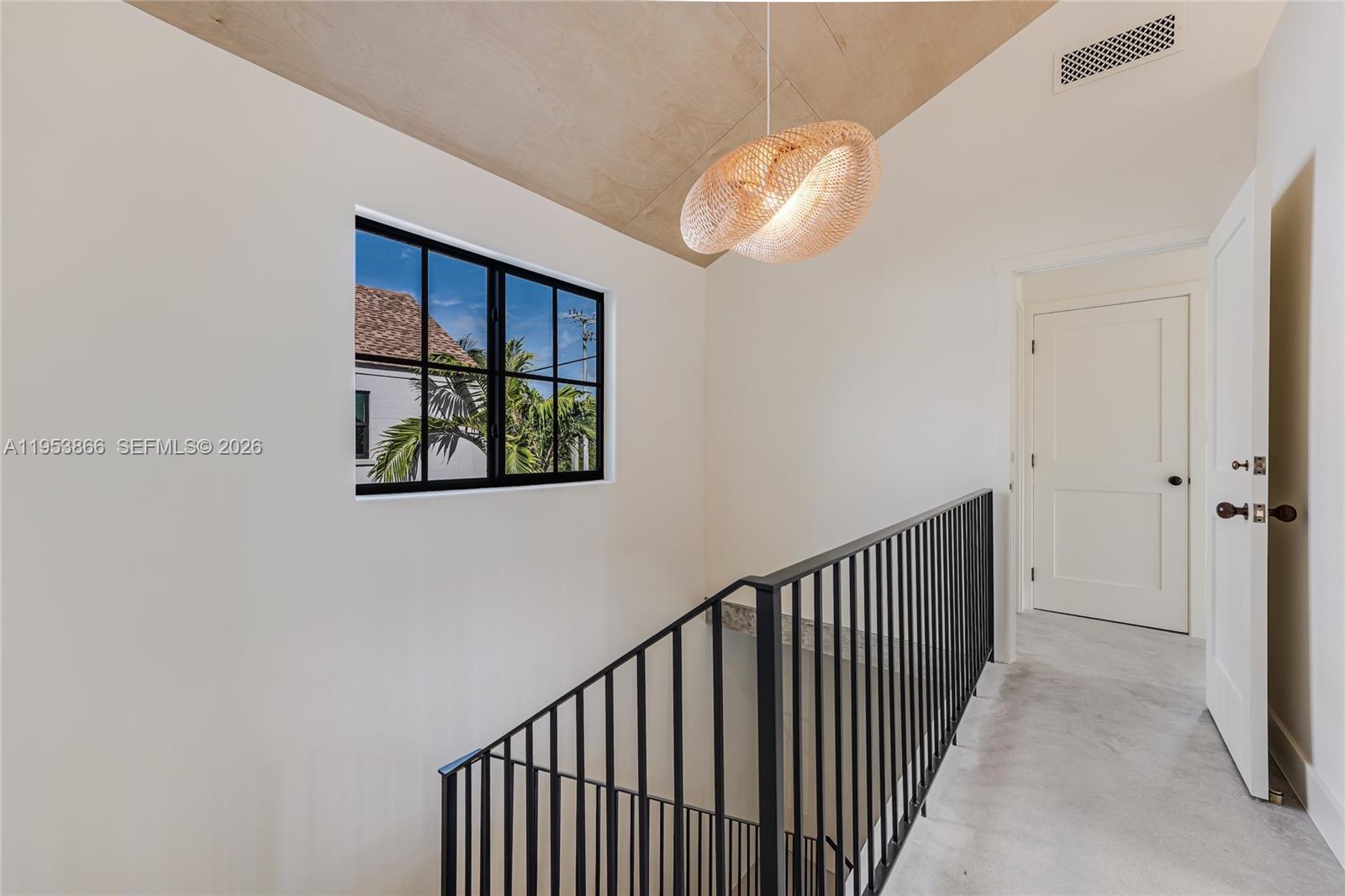 3603 Thomas Avenue Miami, FL 33133 - Photo 16 of 29 a view of a hallway with wooden floor and a chandelier