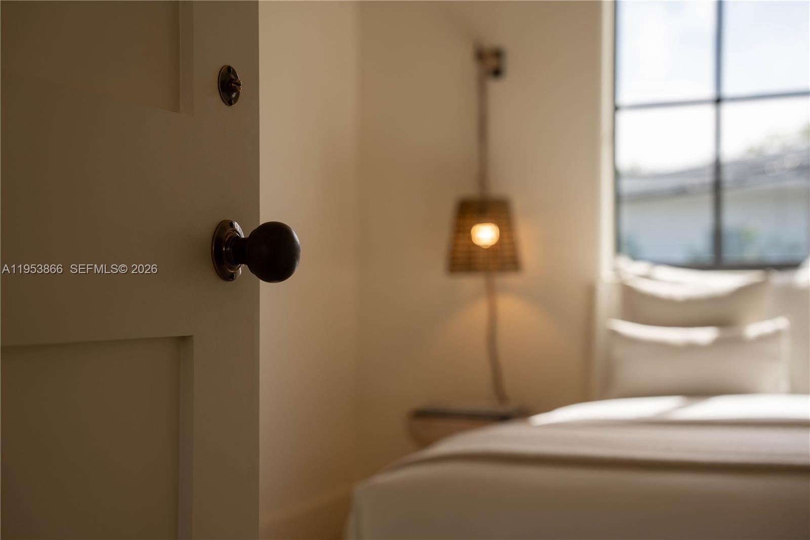 3603 Thomas Avenue Miami, FL 33133 - Photo 22 of 29 a bedroom with a bed and a chandelier