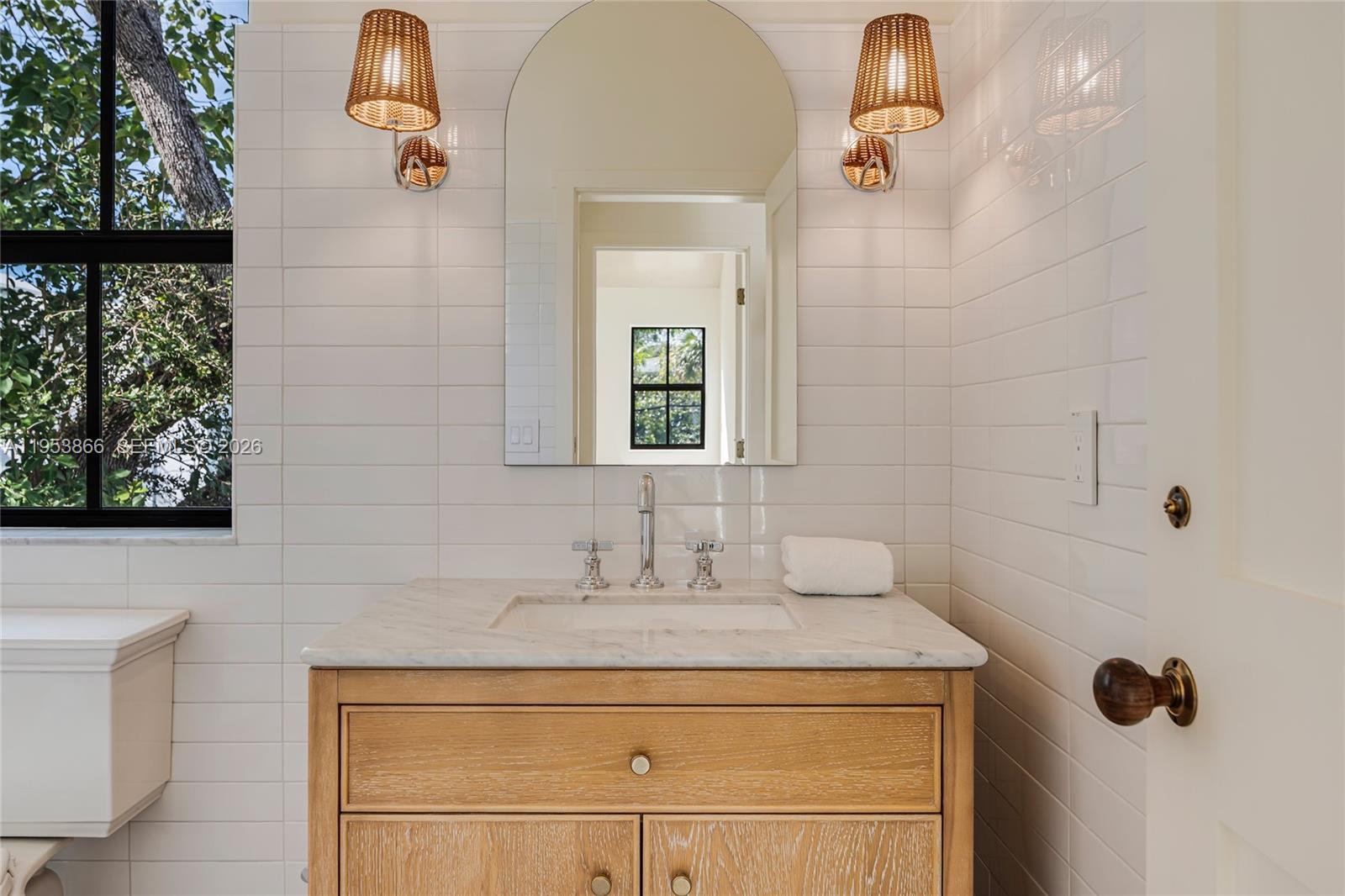 3603 Thomas Avenue Miami, FL 33133 - Photo 26 of 29 a bathroom with a sink and a mirror