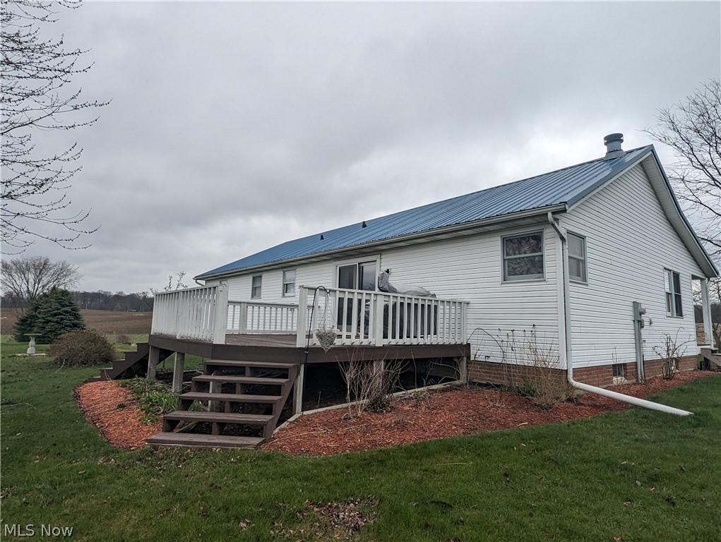 6333 Rochester Road East Rochester, OH 44625 - Photo 5 of 47 Rear view of house featuring a deck and a lawn