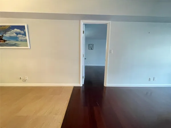 a view of wooden floor and windows in a room