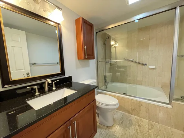 a bedroom with a bed and a night stand