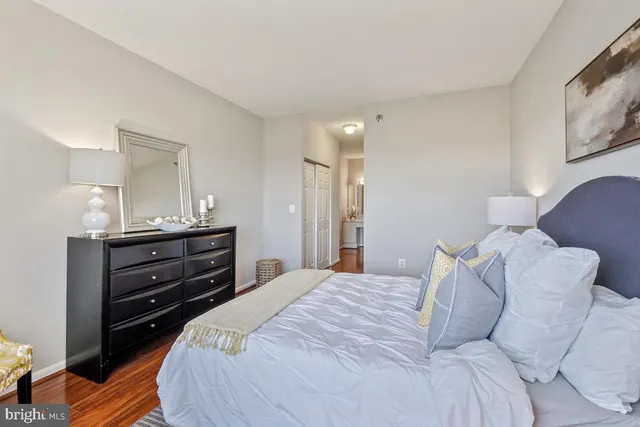 a bedroom with a bed and a mirror