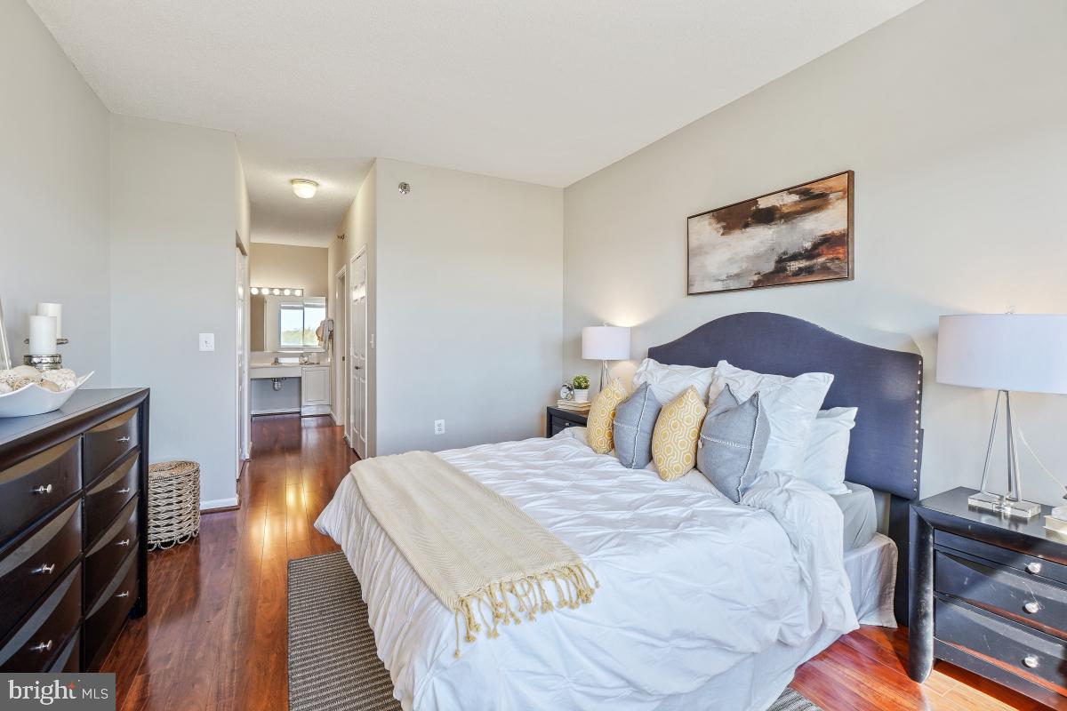 3005 South Leisure World Boulevard, Unit 624 Silver Spring, MD 20906 - Photo 18 of 53 a spacious bedroom with a bed and wooden floor