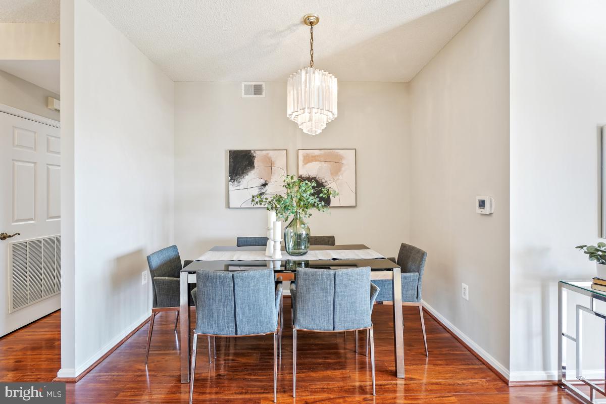3005 South Leisure World Boulevard, Unit 624 Silver Spring, MD 20906 - Photo 2 of 53 a dining room with furniture potted plants and wooden floor