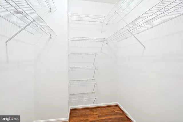 a view of walk in closet with clothes