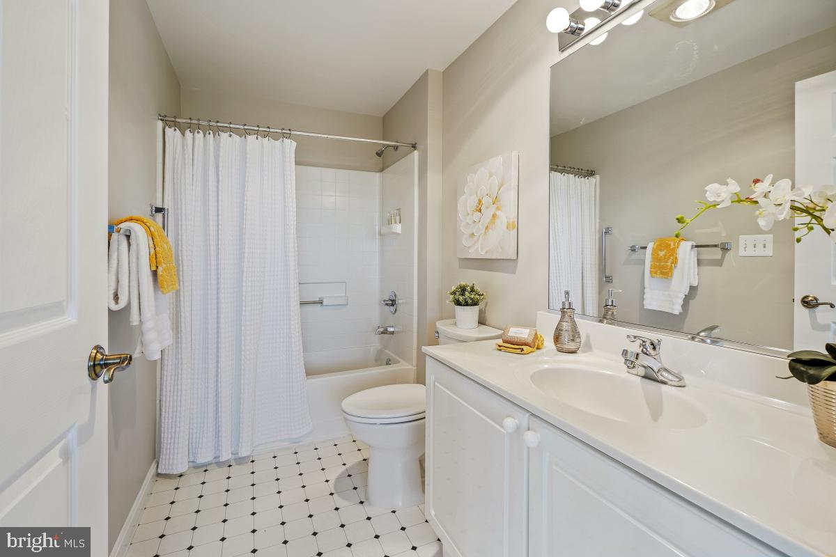 3005 South Leisure World Boulevard, Unit 624 Silver Spring, MD 20906 - Photo 25 of 53 a bathroom with a sink a toilet and shower