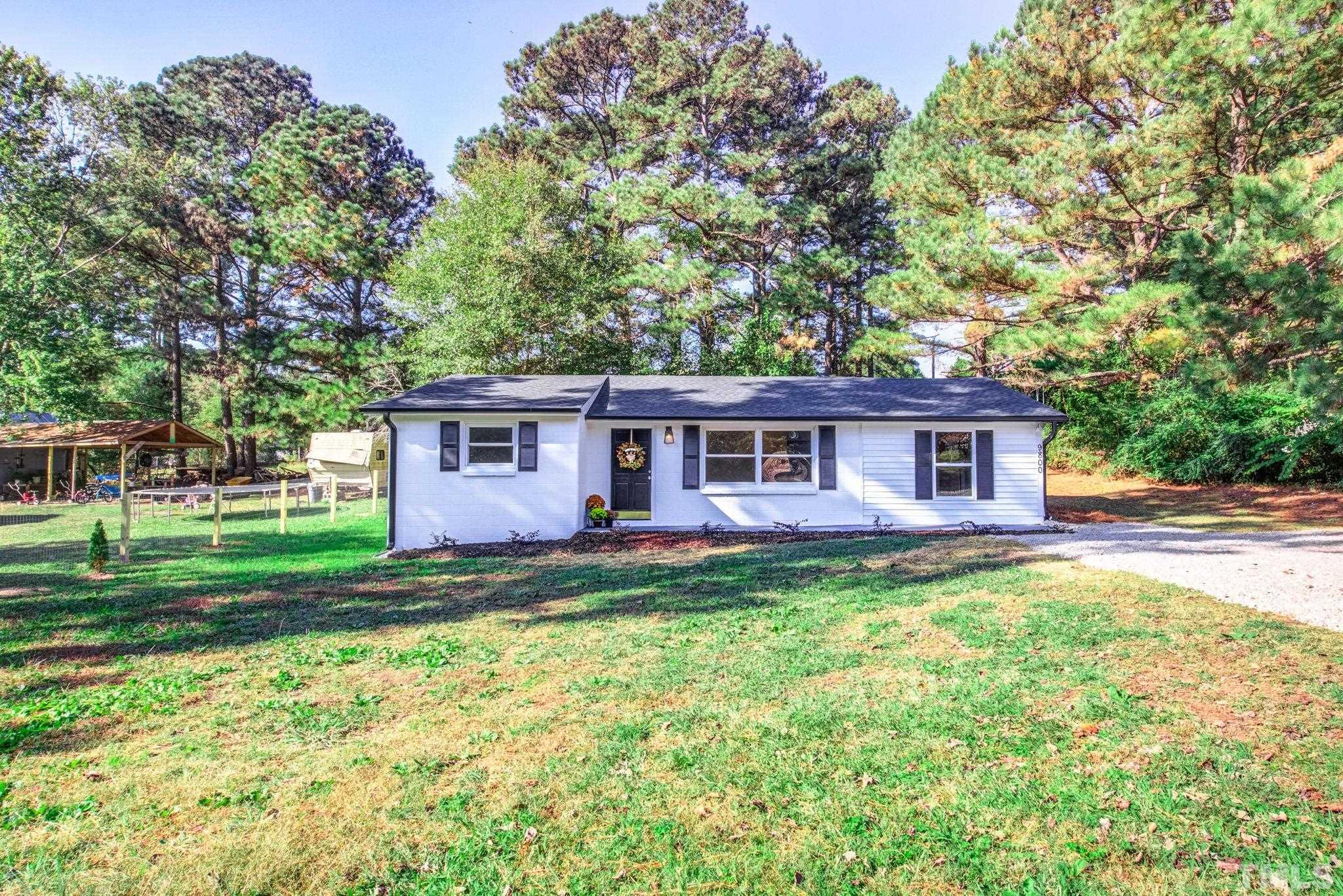 9800 Fanny Brown Road Raleigh, NC 27603 - Photo 3 of 29 a view of a yard in front of a house with large trees