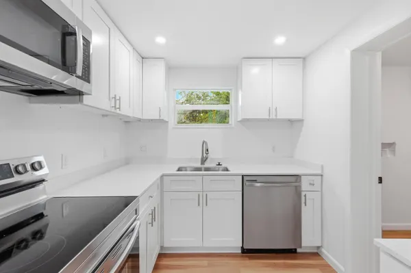 a kitchen with a sink cabinets and stainless steel appliances