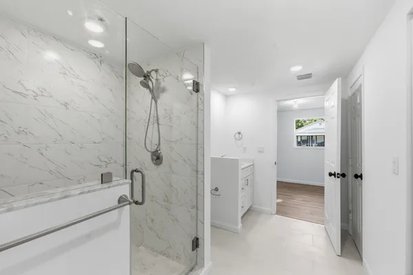 a bathroom with a shower and a sink