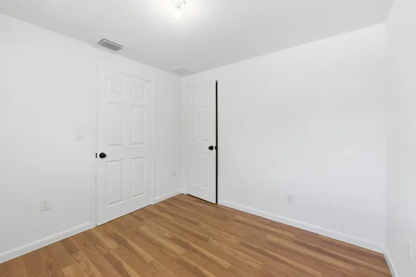 a view of a room with wooden floor