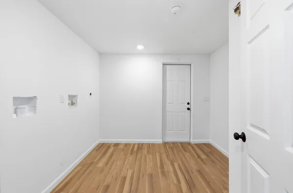 a view of a room with wooden floor