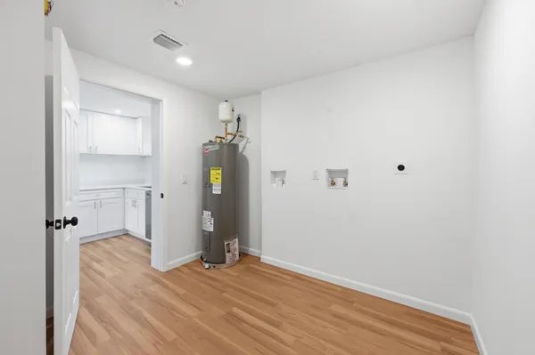 a view of empty room with wooden floor