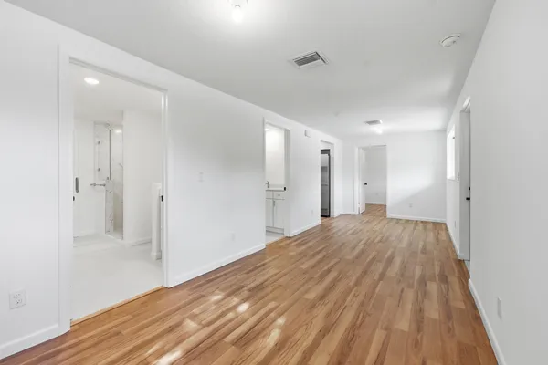 a view of a room with wooden floor and bathroom