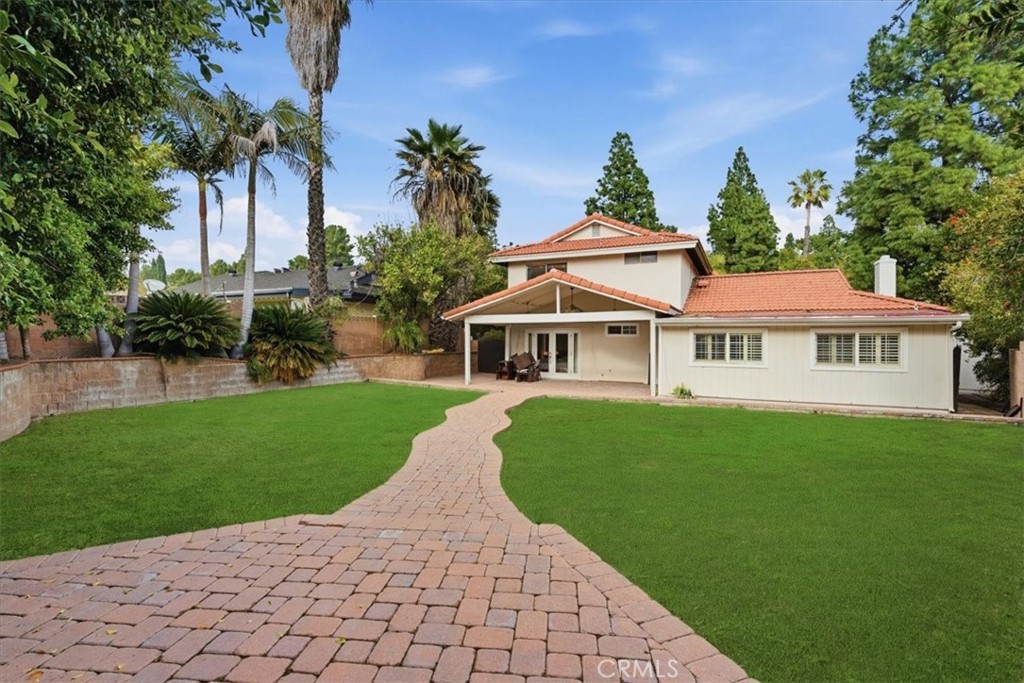 11413 Etiwanda Avenue Porter Ranch, CA 91326 - Photo 15 of 49 a front view of a house with a garden