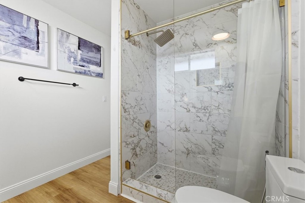 11413 Etiwanda Avenue Porter Ranch, CA 91326 - Photo 21 of 49 a bathroom with a shower and toilet