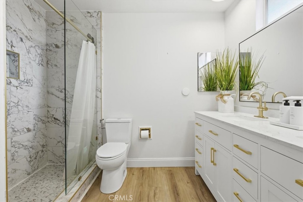11413 Etiwanda Avenue Porter Ranch, CA 91326 - Photo 22 of 49 a bathroom with a granite countertop sink toilet and shower