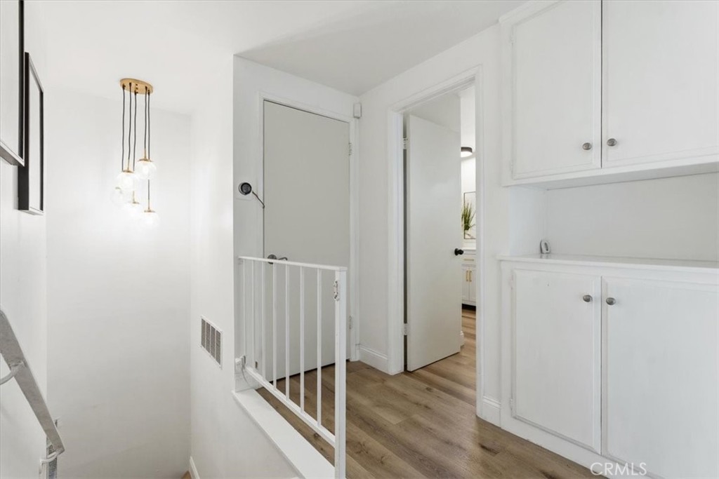 11413 Etiwanda Avenue Porter Ranch, CA 91326 - Photo 26 of 49 a view of a hallway with wooden floor and entryway