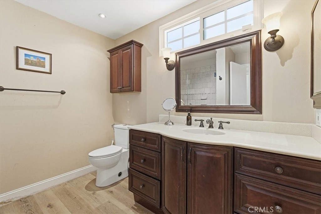 11413 Etiwanda Avenue Porter Ranch, CA 91326 - Photo 29 of 49 a bathroom with a toilet sink and mirror