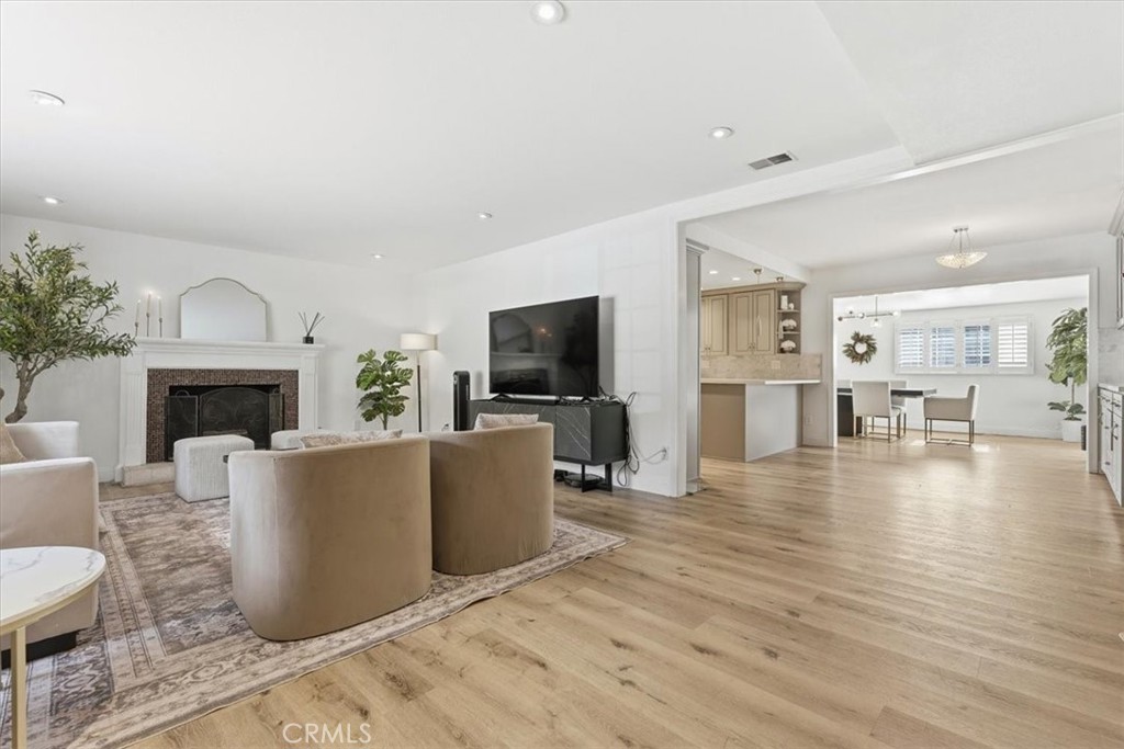11413 Etiwanda Avenue Porter Ranch, CA 91326 - Photo 48 of 49 a living room with furniture a flat screen tv and a fireplace
