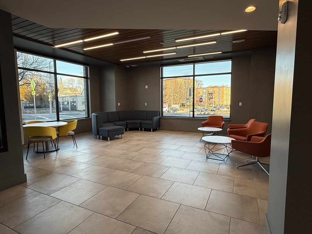 466 River Street, Unit 308 Boston, MA 02126 - Photo 16 of 17 a living room with furniture and a large window